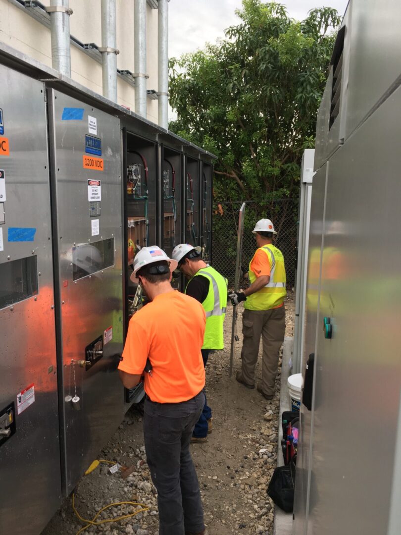 A group of men in hard hats and safety vests.