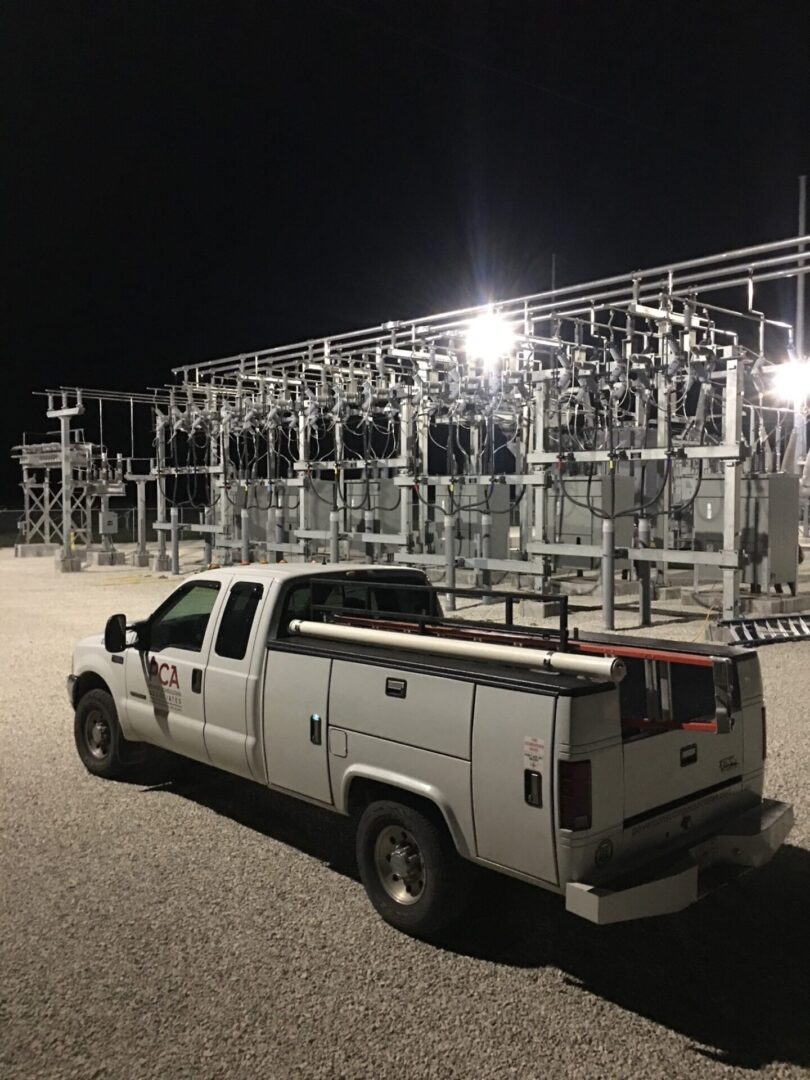 A truck parked in front of electrical equipment.