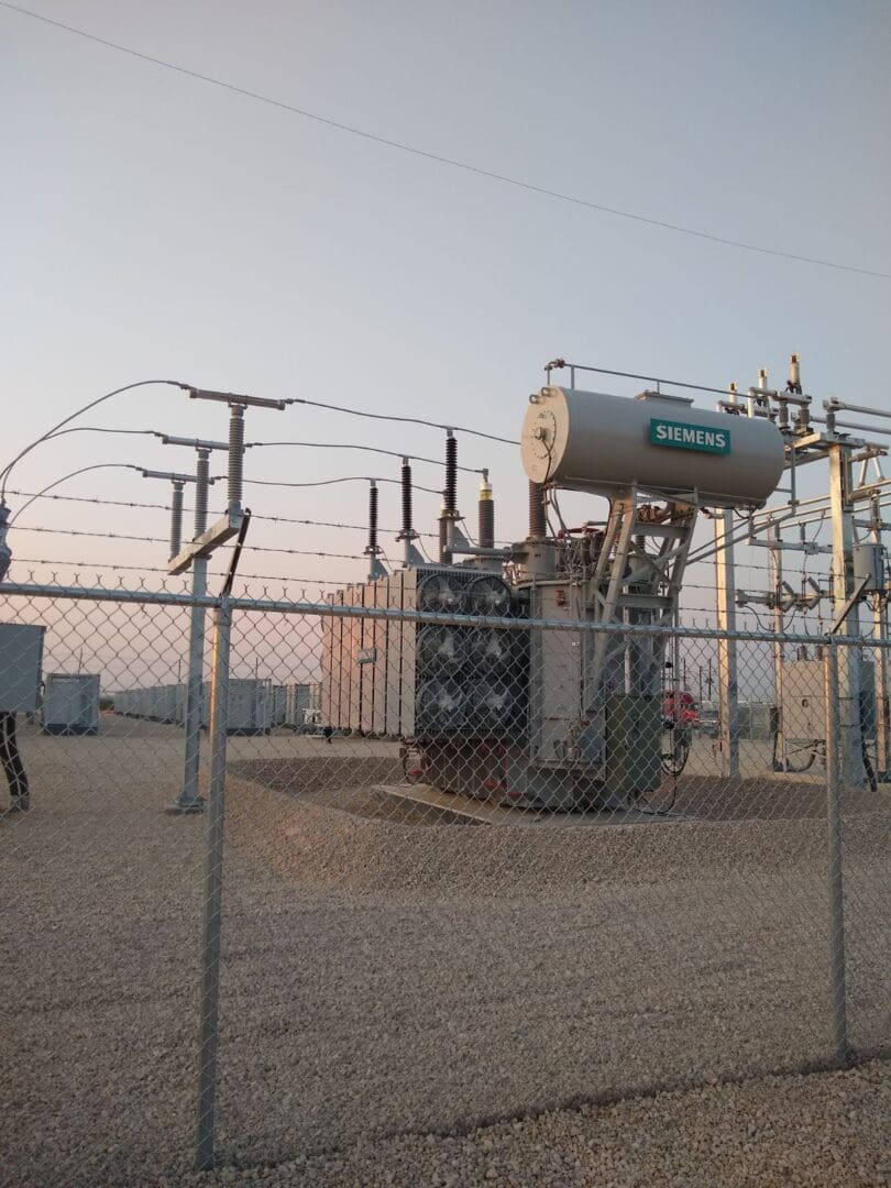 A power plant with many wires and tanks
